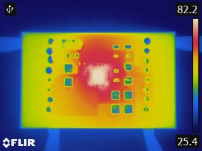 Thermal camera image of a conventional linear regulator board converting 10 V to 3.3 V at 180 mA: the board glows yellow and red, with the regulator white-hot at 82.2 °C.
