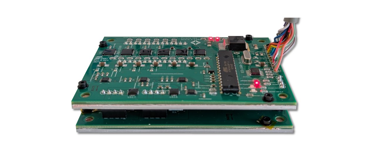 Polaris flight experiment hardware: two stacked green circuit boards carrying Enhanced Linear Regulators and telemetry electronics, with a wiring harness, integrated for the MISSE-21 platform on the International Space Station.